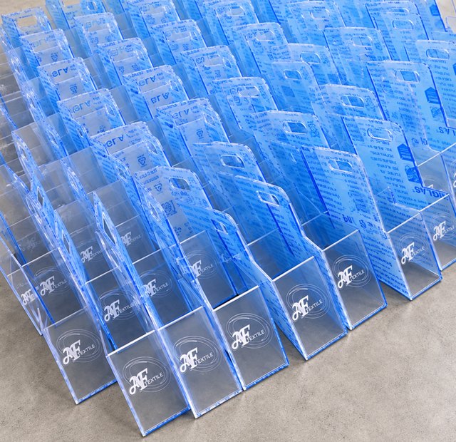 Rows of UV-printed perspex holders branded for AF Textile