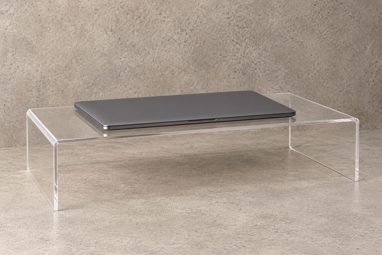 Clear Perspex laptop riser in a considered workspace